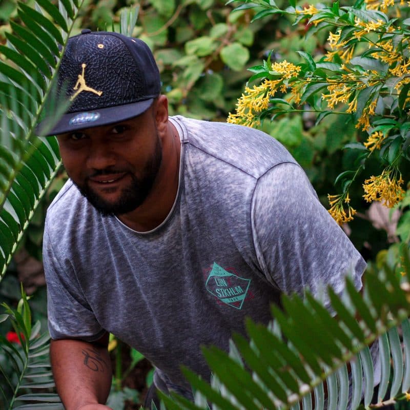 Marcus Ellison, founder of Coastal Sage Landscape, in a planted garden